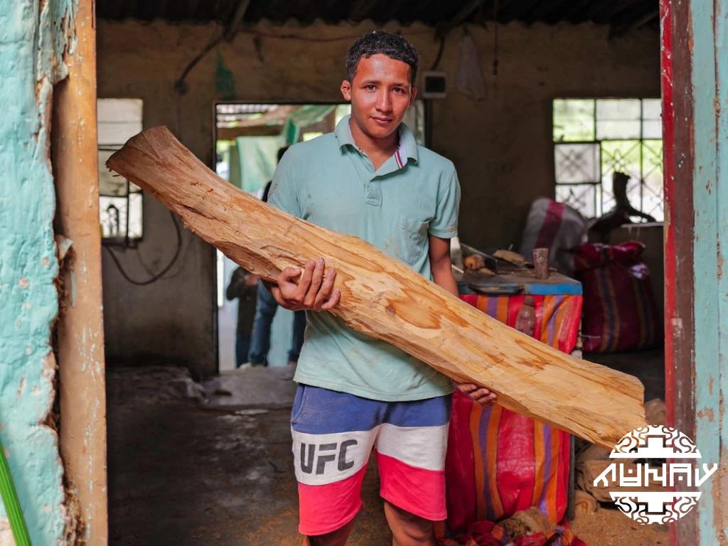 Man holding authentic Palo Santo trunk